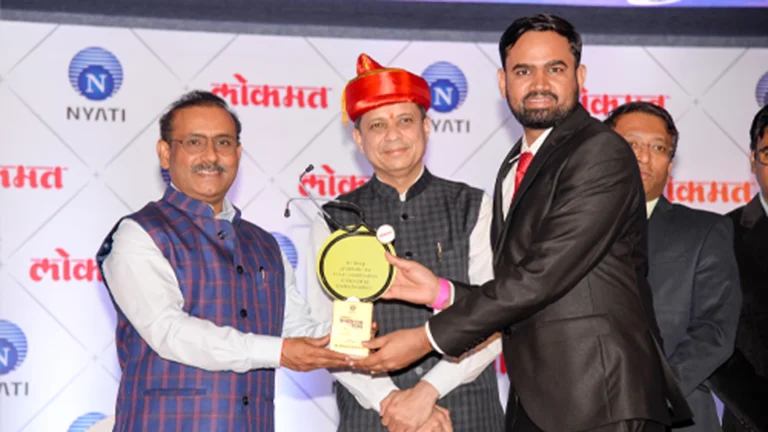 Dr. Kiran Chotaliya receiving an award for excellence in hair transplant surgery